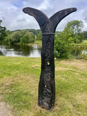 a statue of a largefork in the grass near a river at Robins' Rest - 22 Caer Beris Luxury Lodge Park NEW Sleeps 6 Riverside Reteat in Builth Wells