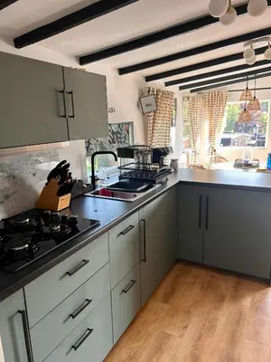a kitchen with white cabinets and a stove top oven at Robins' Rest - 22 Caer Beris Luxury Lodge Park NEW Sleeps 6 Riverside Reteat in Builth Wells