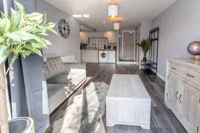 a living room with a couch and a table at Mermaids Hideaway in Aberaeron