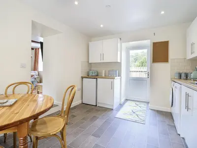 a kitchen with a wooden table and a dining room at 1 Y Llew in Llandinam