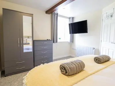 a bedroom with a bed with two pillows on it at 1 Y Llew in Llandinam