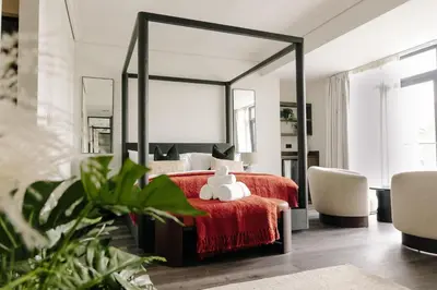 a bedroom with a red bed with a large mirror at Ty Glyn Hotel in Ciliau-Aeron