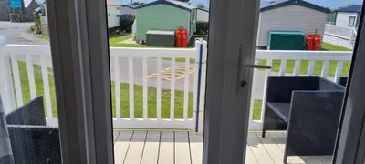 a view of a porch with a white fence at Sher, My Happy super static -2026 Award winner in Llanddwywe