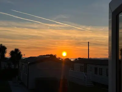 a sunset with the sun setting in the sky at Sher, My Happy super static -2026 Award winner in Llanddwywe