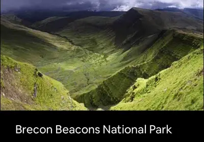a view of a green mountain with the words dragon beacons national park at Kookaburra Cottage in Brecon