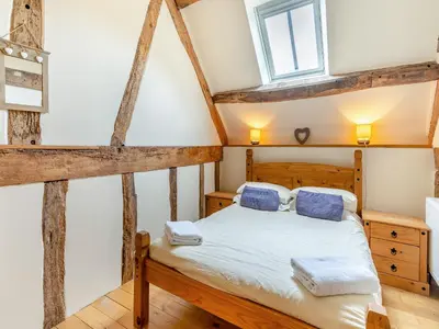 a bedroom with a bed and a window at Wern Farm Barn in Cwmdu