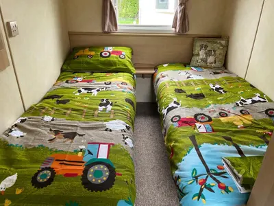 two beds in a small room with two bedsskirts at Sylvan in Builth Wells