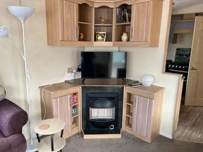 a living room with a tv and a fireplace at Sylvan in Builth Wells