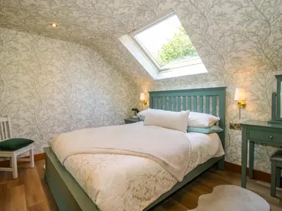 a bedroom with a bed with a skylight at The Hideaway in Shrewsbury