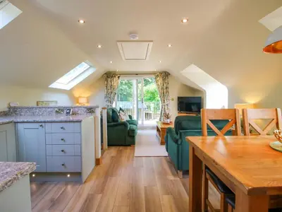 a kitchen and living room with a couch and a table at The Hideaway in Shrewsbury