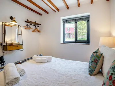 a bedroom with a white bed and a window at The Old Cowsheds 4 - Daniel Ddu - Uk49789 in Cribyn