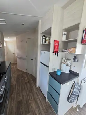 a kitchen with a white refrigerator and a counter at 6 Birth Caravan Quay West Sea Views in New Quay