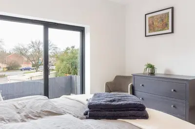 a bedroom with a bed and a dresser and a window at Zest Homes 87b Bridge Street in Leominster