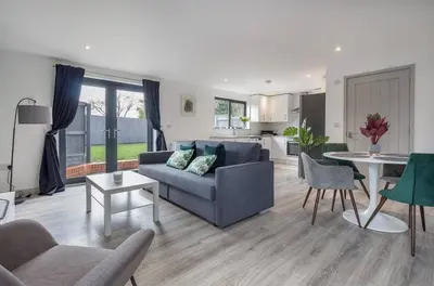 a living room with a couch and a table at Zest Homes 87b Bridge Street in Leominster