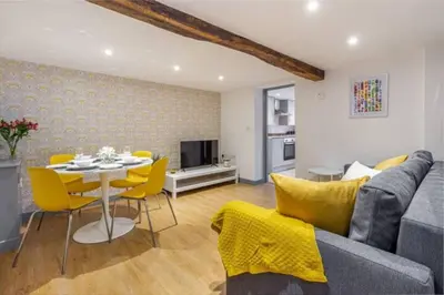 a living room with a couch and a table and chairs at Zest Homes 87 Bridge Street in Leominster