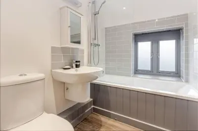 a bathroom with a toilet and a sink and a tub at Zest Homes 87 Bridge Street in Leominster