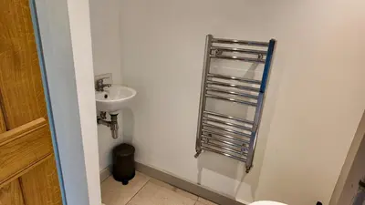 a white bathroom with a sink and a toilet at Zest Homes 87a Bridge Street in Leominster