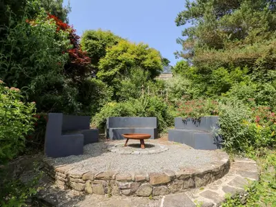 a bench and a table in a garden at The Old Barn in Lampeter