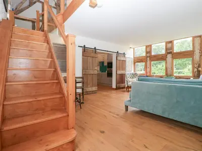 a living room with a staircase and a couch at The Art House in Leominster