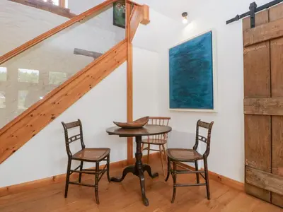 a dining room with a table and two chairs at The Art House in Leominster