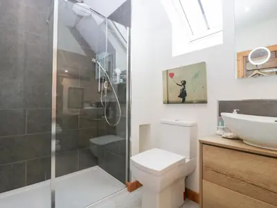 a bathroom with a shower and a toilet and a sink at The Art House in Leominster