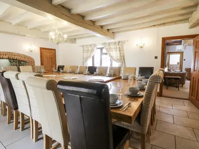a large dining room with a table and chairs at Stud Farm House in Knighton