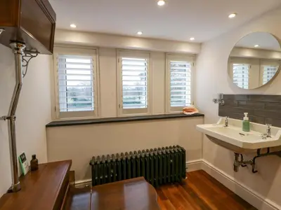 a bathroom with a sink and a mirror at The Retreat at Glanrannell Park House in Llanwrda