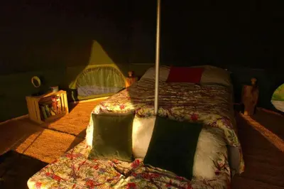 a bedroom with a large bed in a tent at Glamping Pod - Sleeps 2 - Pets - Parking - Wifi in Llanon