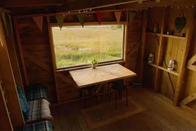 a small table in a room with a window at Glamping Pod - Sleeps 2 - Pets - Parking - Wifi in Llanon