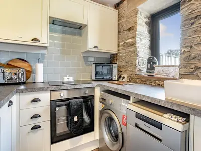 a kitchen with a washer and dryer at The Old Cowsheds 2 - Shippon - Uk49787 in Cribyn