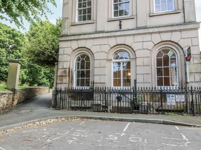 a building with a fence in front of it at 1C College Hill in Shrewsbury