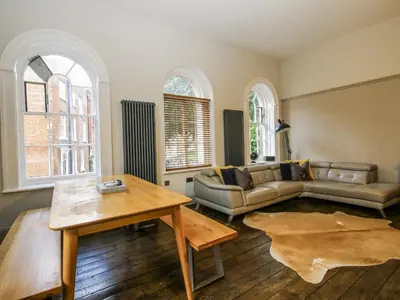 a living room with a couch and a table at 1C College Hill in Shrewsbury