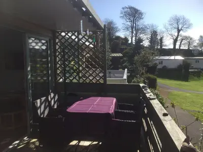 a porch with a purple bench on top of it at Snowdonia 1-Bed Chalet Sleeps 2 Stunning Views in Pennal