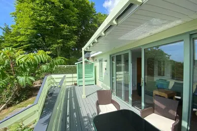a house with a deck with chairs and windows at Snowdonia 1-Bed Chalet Sleeps 2 Stunning Views in Pennal