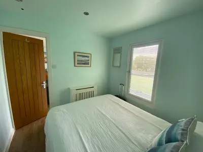 a bedroom with a bed and a window at Snowdonia 1-Bed Chalet Sleeps 2 Stunning Views in Pennal