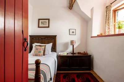 a bedroom with a bed and a table and a window at Ty Neuadd in Dolgellau