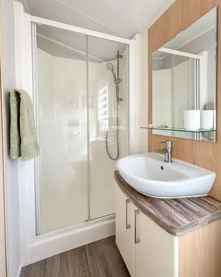 a bathroom with a sink and a shower at Sanderling, 289 Ynyslas Beach, Borth in Borth