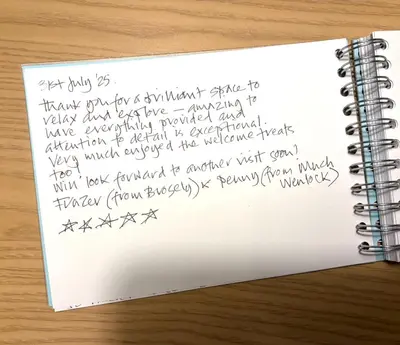 a handwritten letter in a notebook on a table at Sanderling, 289 Ynyslas Beach, Borth in Borth