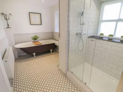 a bathroom with a bath tub and a shower at Bwthyn Mawr in Harlech