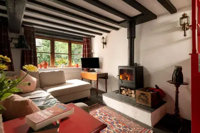 a living room with a fireplace and a couch at Ty Trol in Dolgellau