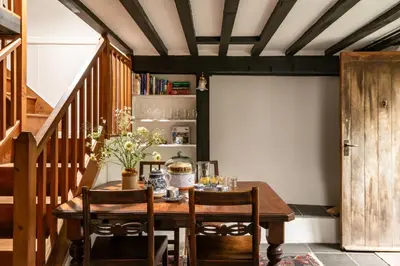 a dining room with a wooden table and chairs at Ty Trol in Dolgellau