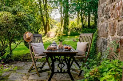 a table and two chairs on a patio at Gwanas Fawr in Dolgellau