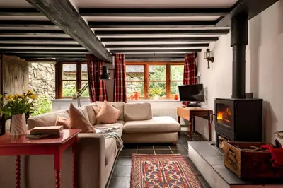 a living room with a couch and a fireplace at Gwanas Fawr in Dolgellau