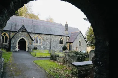 an old stone church with an archway in front of it at Woodcutters' Cabin Authentic Log Cabin Talybont Aberystwyth SY245DW in Aberystwyth