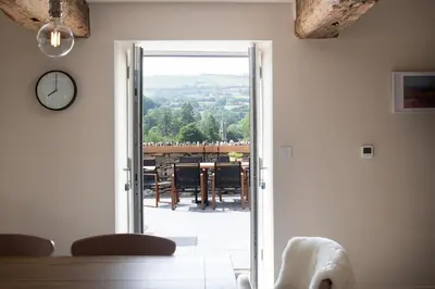 an open door to a dining room with a view at Swn y Nant in Glyn-Ceiriog