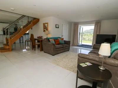 a living room with a couch and a table at Little Penrhosgoch Barn in Llandrindod Wells