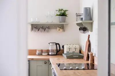 a kitchen with a counter top with a coffee maker at Cosy cottage with stunning views, close to Ludlow in Bucknell