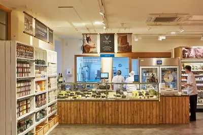 a store with people standing around a counter in a store at Cosy cottage with stunning views, close to Ludlow in Bucknell