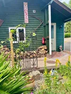 a blue house with a gate in front of it at The Robin, Arrowwood Self Catering in Kington
