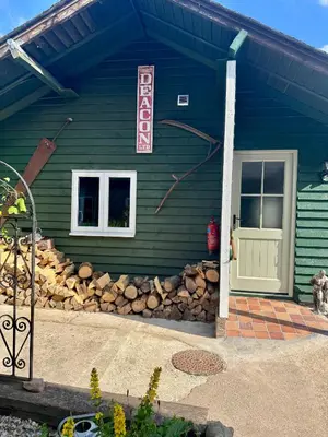 a house with a sign on the side of it at The Robin, Arrowwood Self Catering in Kington